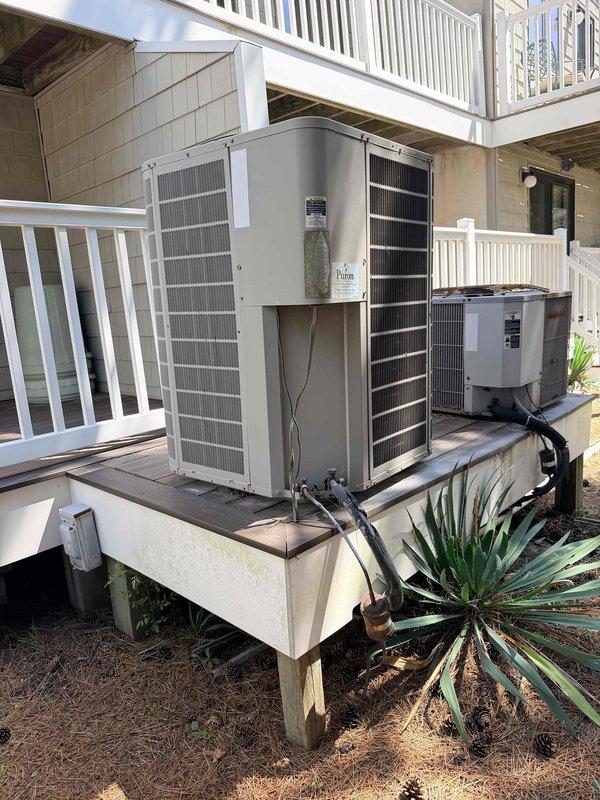 Conducted comprehensive site evaluation for complete HVAC system replacement at oceanside property with in-law suite on first floor. Assessed existing multi-unit outdoor installation featuring heat pump systems mounted on elevated platforms beneath residential deck structure. Documented current electrical infrastructure including main breaker panel showing signs of age and potential moisture exposure. Prepared pricing estimates for three manufacturer options with particular focus on Bosch equipment as requested for the first-floor in-law suite application.