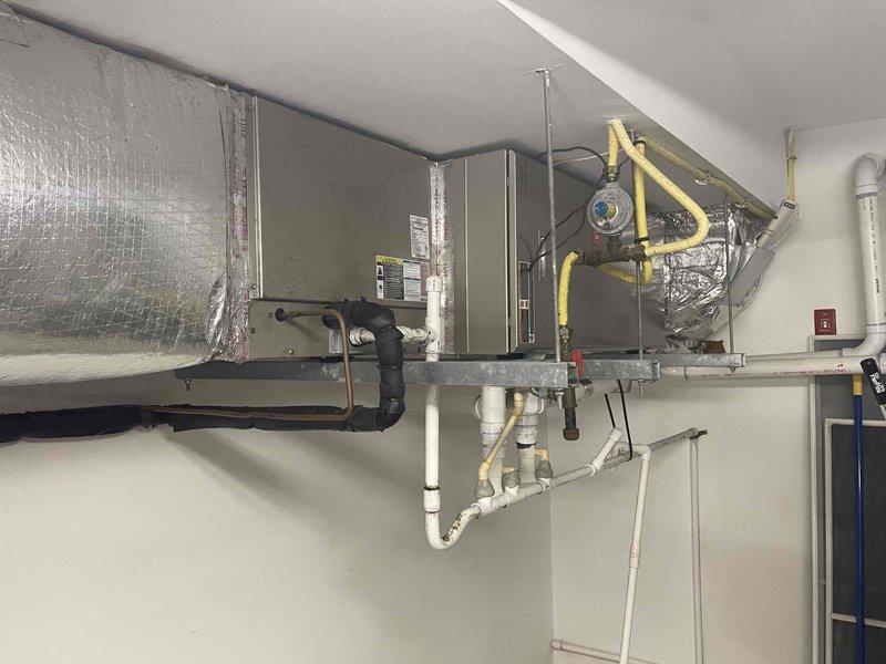 Completed scheduled cooling maintenance visit on two-system HVAC installation. Inspected indoor air handling unit with associated ductwork, refrigerant lines, and condensate drainage system in mechanical room. Verified proper operation of outdoor condensing unit with Puron refrigerant. All components found in good working condition with no immediate repairs required. Systems operating within normal parameters.