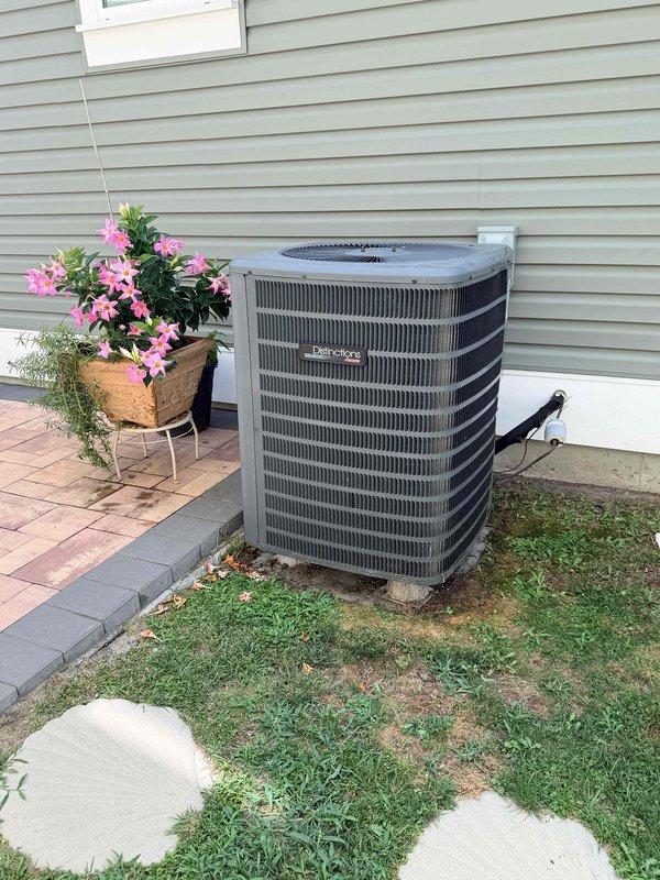 Conducted on-site assessment of existing HVAC system for replacement estimate. Evaluated Comfortmaker outdoor condensing unit installed on concrete pad with visible wear and aging components. Inspected attic-mounted air handler and associated electrical controls, including zone control panel with multiple terminal connections and digital display module. Documented current system configuration, wiring runs, and equipment placement. Photographed existing equipment conditions to support replacement proposal specifications.