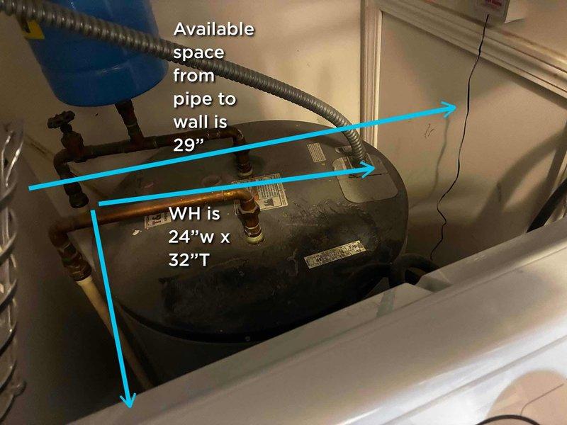 Performed site assessment for water heater replacement in residential utility closet. Documented existing 24"W x 32"H tanked water heater installation with blue expansion tank connected via flexible corrugated metal hose. Verified available clearance space of 29" from existing copper pipe connections to wall to ensure proper sizing for replacement unit. Evaluated plumbing connections including shut-off valves with red handles and standard safety components. Confirmed adequate access in laundry area adjacent to washing machine for equipment removal and installation.