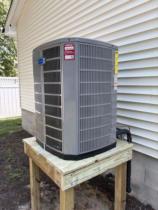 # Complete HVAC System Replacement

Removed and properly disposed of existing HVAC equipment from the property. Installed new outdoor condensing unit on a custom-built pressure-treated wood platform at ground level, ensuring proper elevation and drainage. Mounted new fan coil unit indoors with drain pan and integrated shut-off valve for maintenance accessibility.

Installed electrical whip and disconnect switch to meet code requirements for the outdoor unit. Flushed existing refrigeration lines to remove contaminants, performed pressure testing to verify system integrity, and recharged the system with appropriate refrigerant to manufacturer specifications. All refrigerant lines were properly insulated with foam pipe insulation and secured along the building exterior.

Installed and programmed Honeywell WiFi thermostat, providing remote temperature control and system monitoring capabilities. Verified all electrical connections, tested system operation in both heating and cooling modes, 