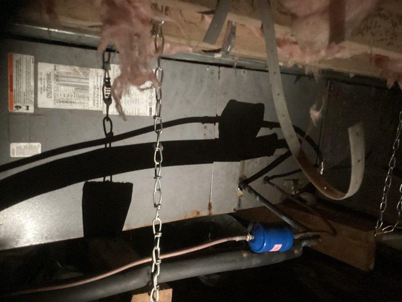 Provided estimate for complete replacement of downstairs HVAC system located in crawl space. Assessed existing chain-mounted air handler unit with refrigerant lines and ductwork, along with dual outdoor condenser units positioned on concrete pad in side yard, and documented current equipment configuration and installation requirements for system replacement.