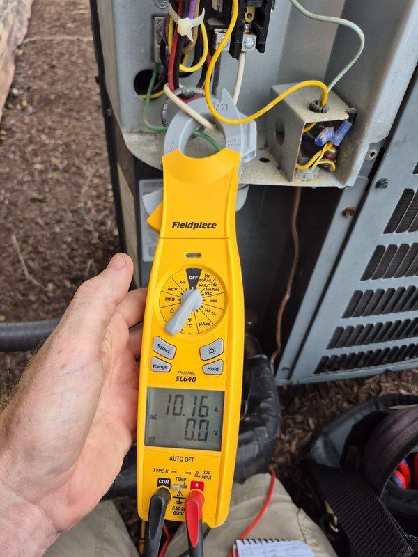 # HVAC Cooling System Maintenance and Inspection

Performed comprehensive cooling system maintenance visit on residential HVAC unit. Upon arrival, conducted thorough electrical diagnostics using calibrated testing equipment to verify proper system operation and electrical parameters. Measured voltage and amperage readings at the unit, with initial readings indicating 10.16 on the diagnostic meter. Inspected all electrical connections, terminal blocks, and wiring configurations within the unit, confirming proper wire terminations and secure connections across all phases.

During inspection, identified significant frost accumulation on evaporator coil and associated components, indicating potential airflow restriction or refrigerant charge issue. Documented temperature reading of 53°F at the affected area using precision digital thermometer. The excessive frost buildup on coil surfaces and surrounding ductwork suggested system was operating outside normal parameters.

Verified all electr