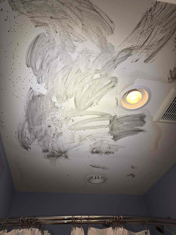 Responded to callback for downstairs zone overcooling issue following recent dual-zone thermostat installation. First floor temperature reading 66°F with thermostat set to 75°F, unit unable to maintain setpoint and continuously running cold. Upon inspection, discovered significant water damage and mold growth on bathroom ceiling directly below attic HVAC equipment, indicating possible condensate drain line failure or overflow. Inspected attic installation area and located PVC condensate drain lines routed through floor joists with vapor barrier present. Identified improper damper configuration or zone control malfunction causing first floor zone to receive excessive airflow regardless of thermostat call. Adjusted zone damper settings and recalibrated zone control board to balance airflow between upstairs and downstairs zones. Verified proper condensate drainage and cleared primary drain line. Advised customer of ceiling water damage requiring remediation and recommended monitoring syst