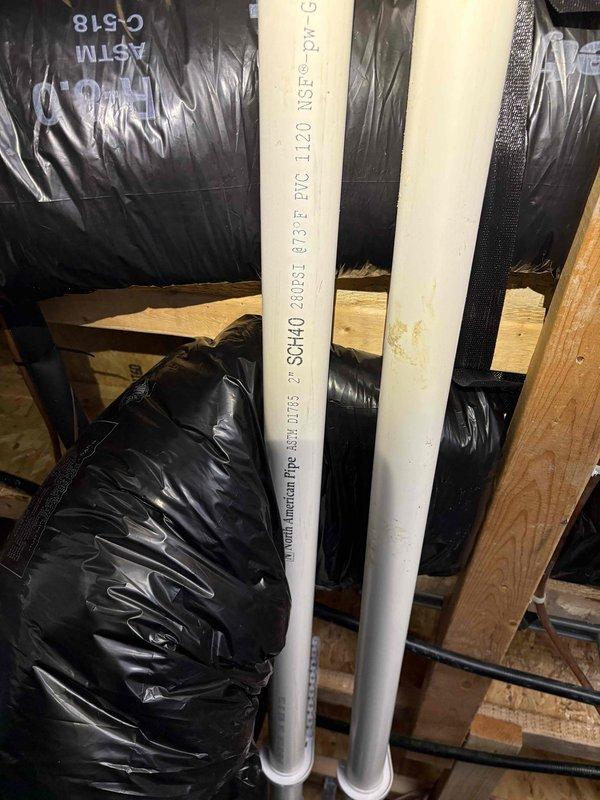 Responded to callback for downstairs zone overcooling issue following recent dual-zone thermostat installation. First floor temperature reading 66°F with thermostat set to 75°F, unit unable to maintain setpoint and continuously running cold. Upon inspection, discovered significant water damage and mold growth on bathroom ceiling directly below attic HVAC equipment, indicating possible condensate drain line failure or overflow. Inspected attic installation area and located PVC condensate drain lines routed through floor joists with vapor barrier present. Identified improper damper configuration or zone control malfunction causing first floor zone to receive excessive airflow regardless of thermostat call. Adjusted zone damper settings and recalibrated zone control board to balance airflow between upstairs and downstairs zones. Verified proper condensate drainage and cleared primary drain line. Advised customer of ceiling water damage requiring remediation and recommended monitoring syst