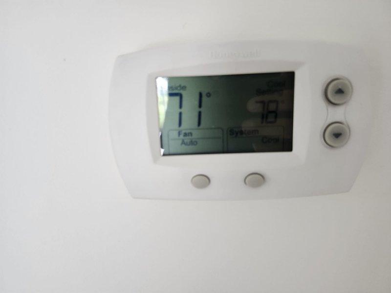 Performed routine tune-up and inspection on residential cooling system. Verified thermostat operation and left set to 78°F cooling mode. Applied company identification stickers to HVAC equipment and water heater per homeowner request for upcoming property sale to ensure new owners have service contact information.