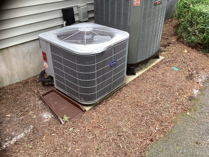 Conducted comprehensive site assessment for complete HVAC system and water heater replacement. Evaluated existing Carrier outdoor condenser unit and indoor furnace system, documented current equipment specifications and installation conditions. Photographed equipment layout including outdoor unit placement on pad with mulch base and indoor furnace/water heater configuration in utility closet. Gathered necessary information and completed estimate form for simultaneous replacement of heating, cooling, and water heating systems.