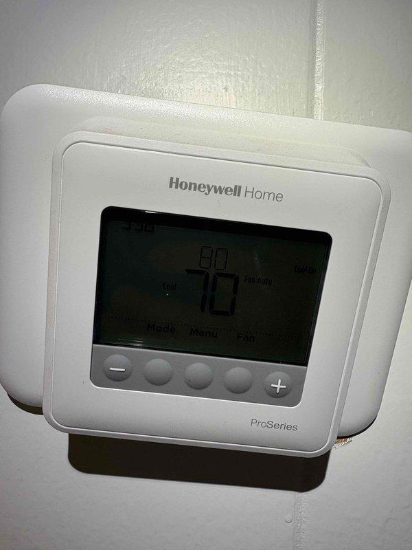 Responded to no cooling complaint at residential property where new homeowner reported inadequate cooling performance following recent packaged terminal unit installation by previous owner. Upon arrival, found thermostat set to 80°F with current temperature reading of 70°F. Accessed attic-mounted HVAC equipment and performed diagnostic testing, measuring supply air temperature at 58.94°F at the unit. Documented system conditions and thermostat settings with photos for service records. Discussed system performance expectations and potential optimization options with homeowner, including available maintenance programs for ongoing system efficiency.