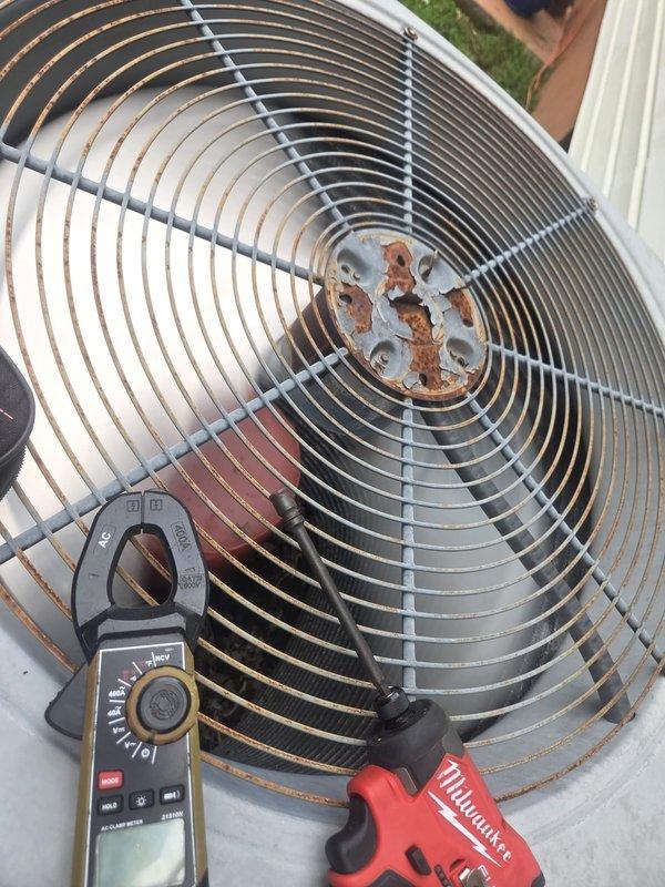 Performed routine cooling system maintenance on residential outdoor condenser unit. Inspected electrical components including capacitor, wiring connections, and control board; all tested within normal operating parameters. Observed moderate rust and corrosion on fan motor hub assembly; monitored for future service needs but unit currently operating efficiently.