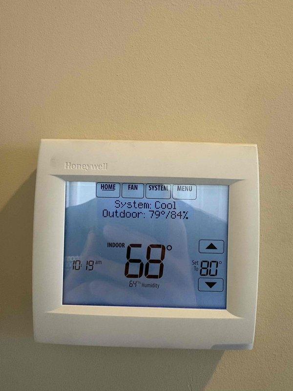 Completed installation of Honeywell automatic zone damper system for first floor cooling issue. System included HZ432 zone control board, ARD10TZ 10" round damper, ARD8 round bypass damper, ZD8X8 and ZD8X14 zone dampers, THM400R1000 wireless adapter, TH8321R1001 RedLink thermostat, and THM6000R7001 RedLink equipment interface. Zone dampers installed in ductwork to regulate airflow distribution throughout multiple zones. Bypass damper installed to maintain proper static pressure when zones close. Wireless thermostat mounted and programmed, currently displaying 68°F indoor temperature with setpoint of 80°F in cooling mode. Zone control board wired and configured to communicate with thermostat and damper actuators. System tested and verified proper operation of all zone dampers, thermostat communication, and cooling cycle. One-year labor warranty provided on installation.