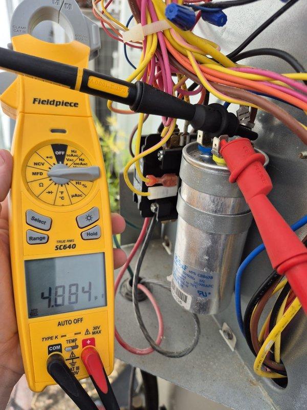 Performed re-inspection of single cooling system as requested. Conducted comprehensive electrical diagnostics using digital multimeter, measuring voltage and capacitance readings to verify proper system operation. All electrical components tested within normal operating parameters, capacitor readings confirmed at acceptable levels, and system found operating efficiently with no deficiencies noted.