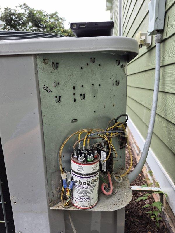 Completed reinspection of HVAC system following previous service visit. Inspected outdoor disconnect box and electrical connections, verifying proper wire terminations and component functionality. Documented existing Turbo200 capacitor installation with all electrical connections secure and operational. System operating within normal parameters.