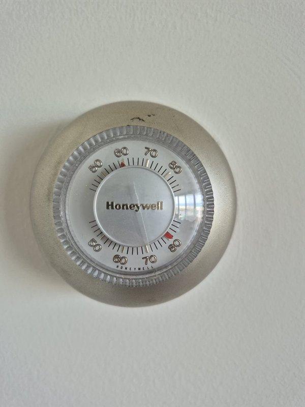 Responded to no cooling complaint on residential HVAC system. Performed diagnostic evaluation including temperature measurements at return air grille, which indicated supply air temperature of 63°F. Inspected mechanical thermostat operation and system response. Discussed findings with customer and provided repair estimate exceeding diagnostic fee threshold. Documented system conditions with photographs for service records.