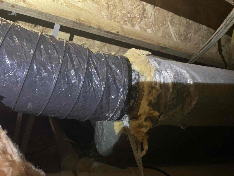 Responded to service call for disconnected and damaged flexible ductwork in crawl space initially identified by plumber. Upon inspection, found section of flex duct detached from supply vent with torn and shredded insulation jacket. Reattached ductwork to register boot, secured connections with appropriate fasteners and mastic sealant, and replaced damaged insulation sections to restore proper airflow and thermal efficiency to affected zone.