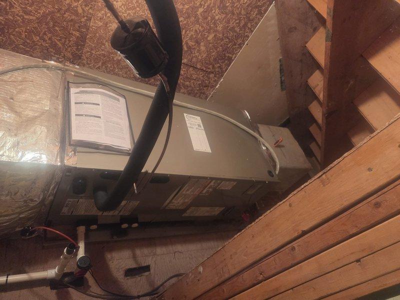 Completed full HVAC system replacement in upstairs attic space. Removed and disposed of existing equipment. Installed new Carrier 27SCA524A003 2-ton 15 SEER heat pump outdoor unit on existing stand with new outdoor disconnect and electrical whip. Installed Carrier FT5ANXB24L00 air handler in attic with Carrier 10 kW electric heat pack. Fabricated and installed metal duct transitions to adapt new equipment to existing ductwork. Reused existing electrical connections, condensate drain lines, and power supply lines where applicable. Installed Honeywell N100 digital thermostat for system control. Connected refrigerant lines between outdoor heat pump and indoor air handler. Verified proper condensate drainage with PVC drain line installation. Tested all electrical connections and system operation. Confirmed proper airflow through ductwork and adequate system performance. Equipment positioned on white platform support structure in attic space with filter access at unit. All installations mee