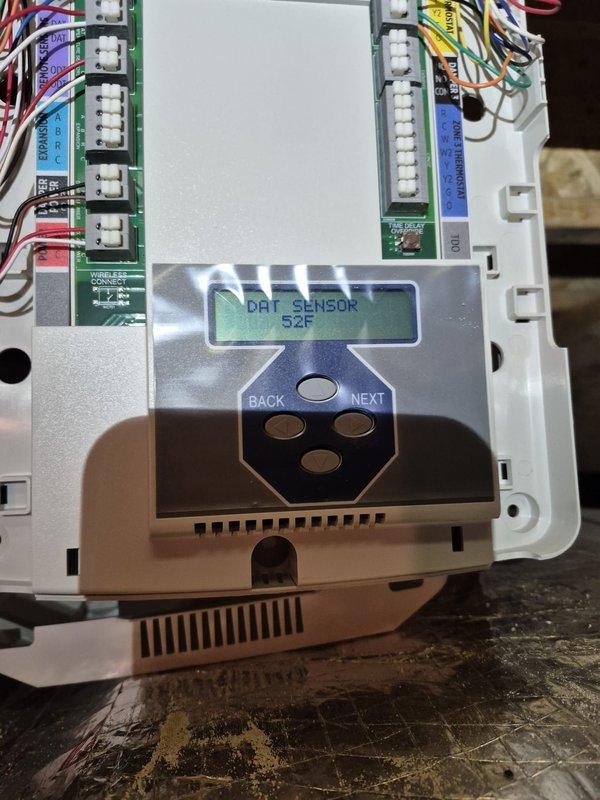 Responded to no cooling complaint on zoned HVAC system. Found tripped breaker which was reset by customer prior to arrival. Troubleshot zone control system and discovered first floor zone damper potentially stuck, preventing proper airflow distribution. Inspected zone control board displaying DAT sensor reading of 52°F and verified proper wiring connections to zone dampers and thermostat. Coordinated with Ecobee thermostat technical support to rule out thermostat programming issues. System operational at time of departure with all zones responding appropriately.