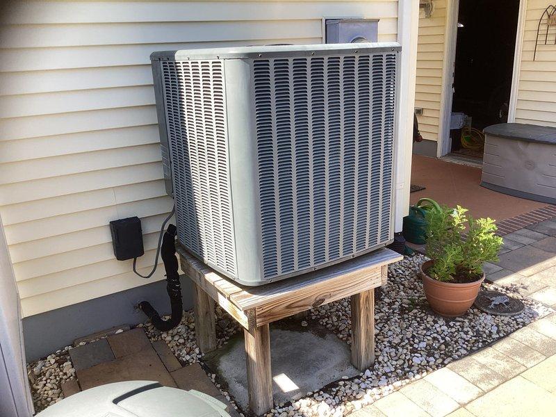 Responded to no cooling call for residential air conditioning system. Upon inspection, found outdoor condenser unit and crawlspace air handler system not operational. Evaluated existing equipment including outdoor condensing unit positioned on wooden platform with proper clearances and crawlspace-mounted air handler with flexible ductwork installation. Performed comprehensive system assessment and provided detailed replacement estimate for complete HVAC system upgrade to restore cooling functionality to the residence.