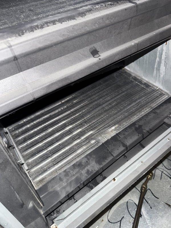 Installed new insulated metal return plenum with integrated filter rack and 16x20x1 filter for attic-mounted air handler. Leveled unit, installed emergency safety switch trap, and sealed air leaks at unit connections including 4" cap installation. Inspected and cleaned evaporator coil to restore proper airflow and system efficiency.