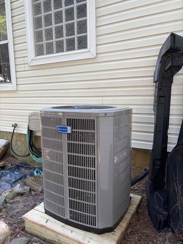 Completed full HVAC system replacement including removal and disposal of existing equipment. Installed 5A6H7036 3-ton 17 SEER heat pump outdoor unit on pressure-treated wood platform with proper electrical whip and disconnect. Installed 5TEM6D04 variable speed fan coil unit indoors with BAYHTT1715BRKR 15KW electric heater with integrated breaker. Flushed, pressure tested, and recharged refrigeration lines to manufacturer specifications. Installed 1-inch filter rack and THX1200W WiFi-enabled thermostat for system control. Verified all electrical connections, tested system operation across heating and cooling modes, and confirmed proper airflow and temperature differential. System commissioned successfully with one-year comprehensive warranty on all new equipment and installation.