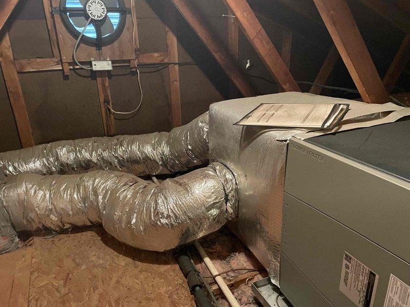 Responded to no cooling call on residential HVAC system less than 10 years old. Upon arrival, performed diagnostic evaluation of attic-mounted air handler and associated ductwork system. Inspected unit operation, verified proper airflow through flexible duct runs, and checked electrical connections at equipment and attic ventilation fan. System evaluated and customer advised of findings requiring repair work exceeding minimum service threshold. Documentation completed with photographic records of attic installation, including air handler placement, flex duct routing, and overall system configuration.