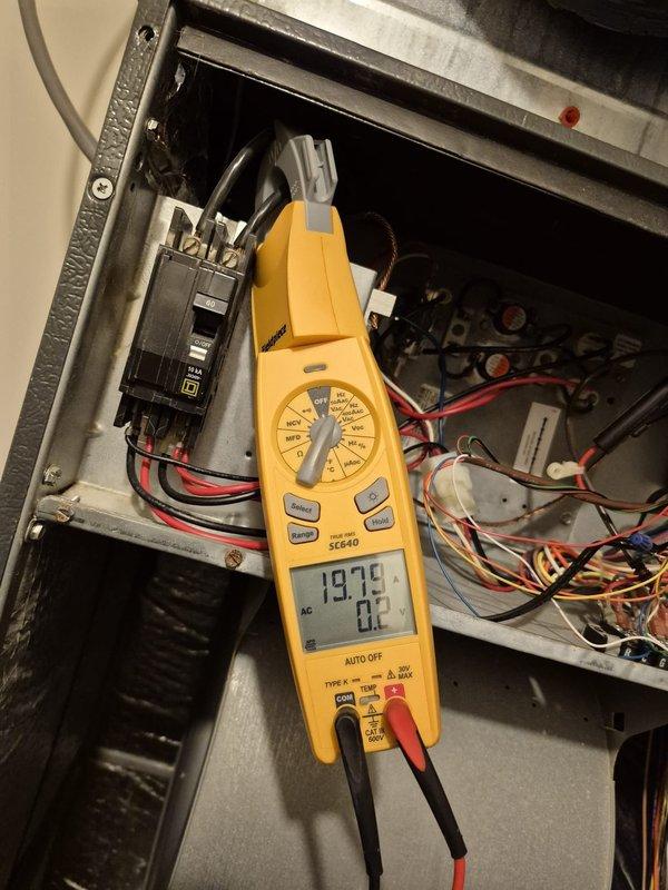 Completed scheduled cooling system maintenance visit. Performed electrical diagnostics on HVAC unit, measuring voltage at 19.79 VDC and current draw at 0.77 amps using digital multimeter and clamp meter to verify proper system operation and circuit functionality.