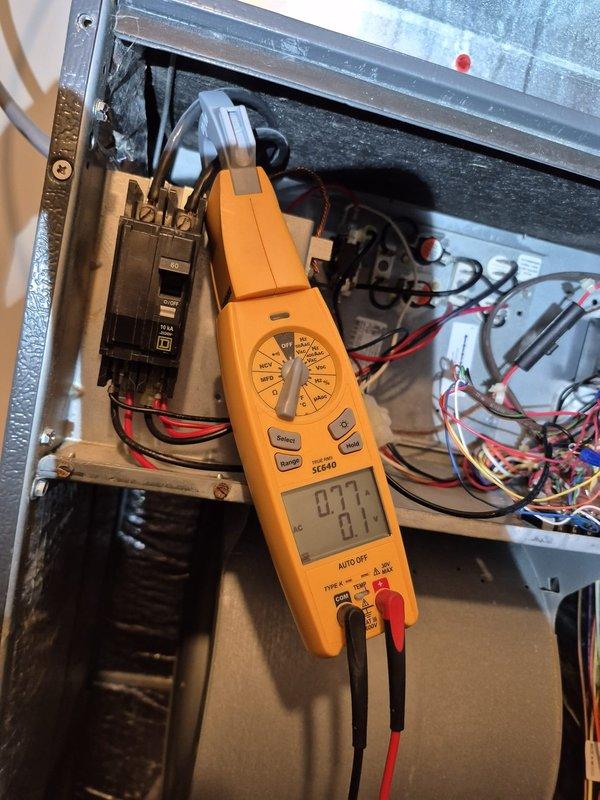 Completed scheduled cooling system maintenance visit. Performed electrical diagnostics on HVAC unit, measuring voltage at 19.79 VDC and current draw at 0.77 amps using digital multimeter and clamp meter to verify proper system operation and circuit functionality.
