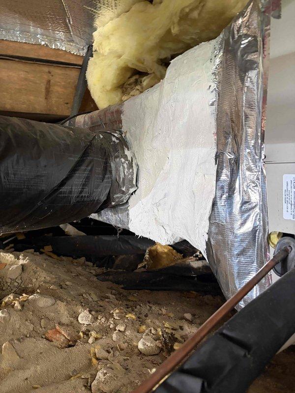 Removed and replaced damaged fiberglass transition box with new insulated metal transition at air handler. Replaced over-stretched flexible ductwork with properly sized flex run to ensure adequate airflow and system efficiency. Relocated condensate drain line to alternative discharge point to prevent water backflow issues. All ductwork properly sealed with foil tape and secured with appropriate mounting brackets in attic crawl space.