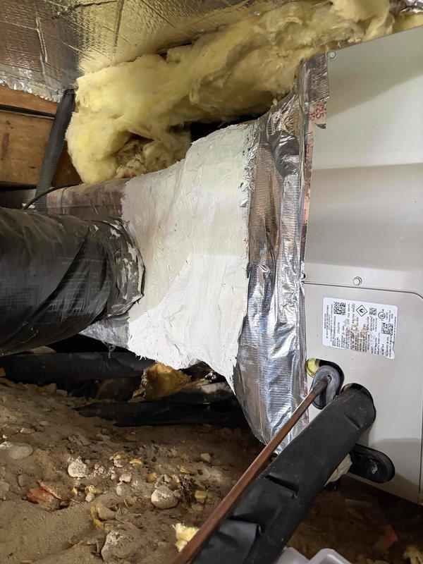 Removed and replaced damaged fiberglass transition box with new insulated metal transition at air handler. Replaced over-stretched flexible ductwork with properly sized flex run to ensure adequate airflow and system efficiency. Relocated condensate drain line to alternative discharge point to prevent water backflow issues. All ductwork properly sealed with foil tape and secured with appropriate mounting brackets in attic crawl space.