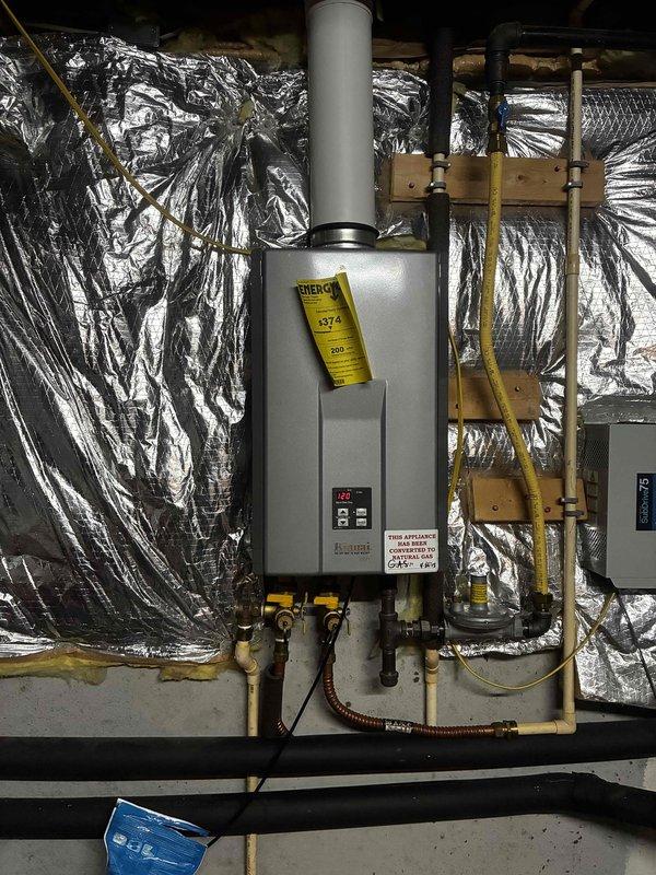 Completed scheduled maintenance inspection on second of two tankless water heater units located in attic space. Performed comprehensive system check including examination of gas connections, water supply lines, exhaust venting, and control panel operation. Verified proper function of all components, confirmed secure mounting, and ensured all connections remain leak-free and properly insulated.