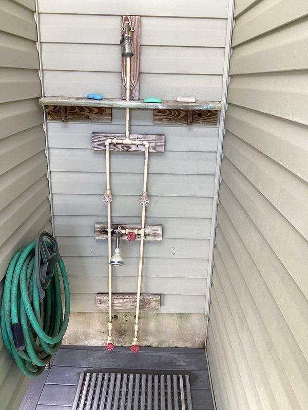 Completed estimate for water heater replacement in residential utility space. Assessed existing tank-style water heater with overhead CPVC manifold distribution system featuring multiple branch lines and shut-off valves. Estimate includes replacement of water heater unit, installation of new supply line shut-off valves, and replacement of flex connectors. Documented current installation configuration showing complex pipe network with blue-handled isolation valves throughout system. Photographed existing conditions for replacement specifications and material requirements.