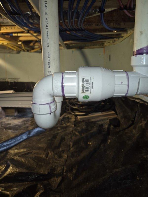 Responded to customer report of dripping sound inside PVC pipe under house. Performed comprehensive inspection of crawl space plumbing system, examining all visible PVC drain lines, P-trap assemblies, and pressure pipe connections. Inspected pipe joints, fittings, and primer applications for signs of moisture, active leaks, or structural defects. Documented existing plumbing configuration including vertical pressure lines and drain assemblies with photographic evidence. No active water leakage or floor damage observed during inspection. All accessible pipe connections, clamps, and support systems found secure and properly installed.