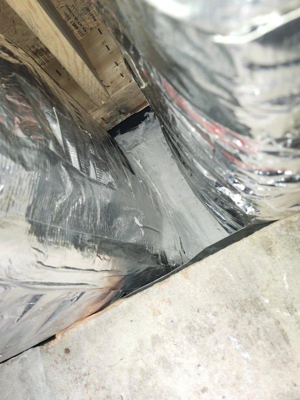 Removed existing gas pack unit and installed metal transitions and sleeves to connect to existing ductwork in crawlspace. Reconnected all electrical wiring and refrigerant piping to new package unit. Installed metal duct shroud between package unit and building exterior to enclose new ductwork and crawlspace opening, then sealed all new duct connections with hardcast tape to ensure proper air sealing and system efficiency.