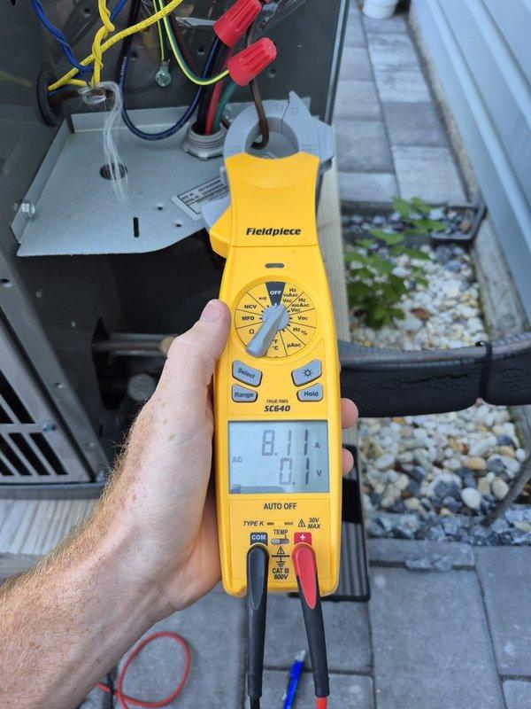 Performed routine cooling maintenance visit on HVAC system. Conducted electrical diagnostics using clamp meter, measuring amperage at 8.1A and voltage at 0.1V on system components. Inspected ductwork, noting accumulated dust and dirt on metal surfaces, and verified all electrical connections at unit panel with proper wire terminations intact.