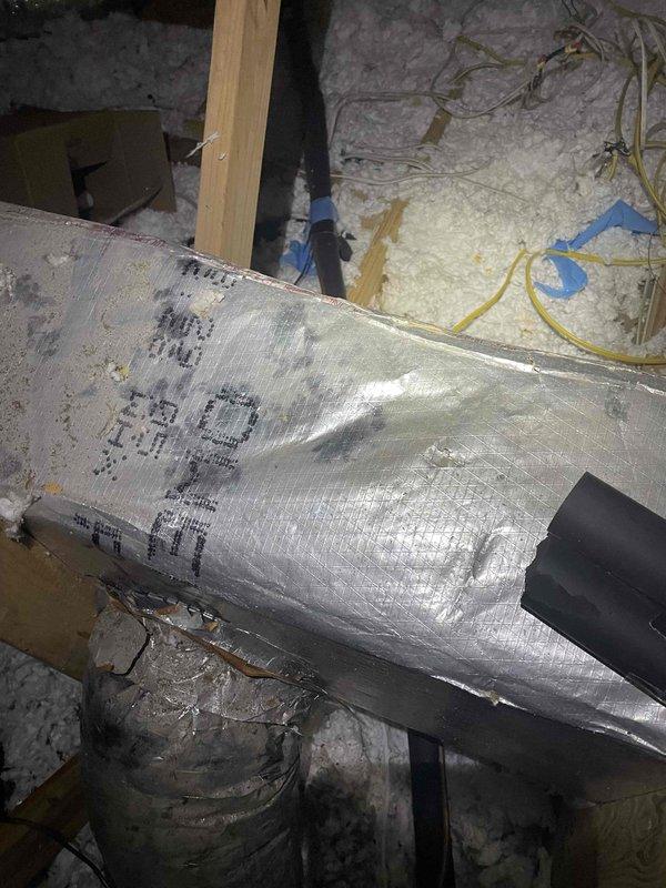 Responded to insufficient airflow complaint on upstairs system serving addition above garage. Inspected attic ductwork and found mixed installation with combination of new and existing duct runs. Evaluated flex duct routing, insulation integrity, and airflow distribution throughout the system to identify restrictions affecting conditioned air delivery to the addition space.