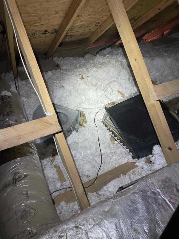 Responded to insufficient airflow complaint on upstairs system serving addition above garage. Inspected attic ductwork and found mixed installation with combination of new and existing duct runs. Evaluated flex duct routing, insulation integrity, and airflow distribution throughout the system to identify restrictions affecting conditioned air delivery to the addition space.