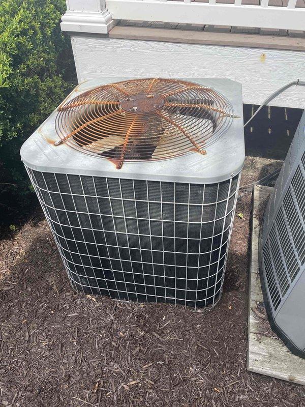 Responded to no cooling complaint on residential split system. Property for sale with recent service by another contractor, unit subsequently failing to maintain temperature. Performed diagnostic evaluation of outdoor condensing unit and indoor air handler system. Inspected condenser fan operation, refrigerant circuit, and electrical components. Examined attic-mounted air handler and ductwork installation for proper airflow and system performance. Documented equipment condition with photos showing outdoor unit placement on mulch bed against building exterior and indoor components in attic space with flexible ductwork visible. Unit not maintaining adequate cooling capacity despite previous service attempt.