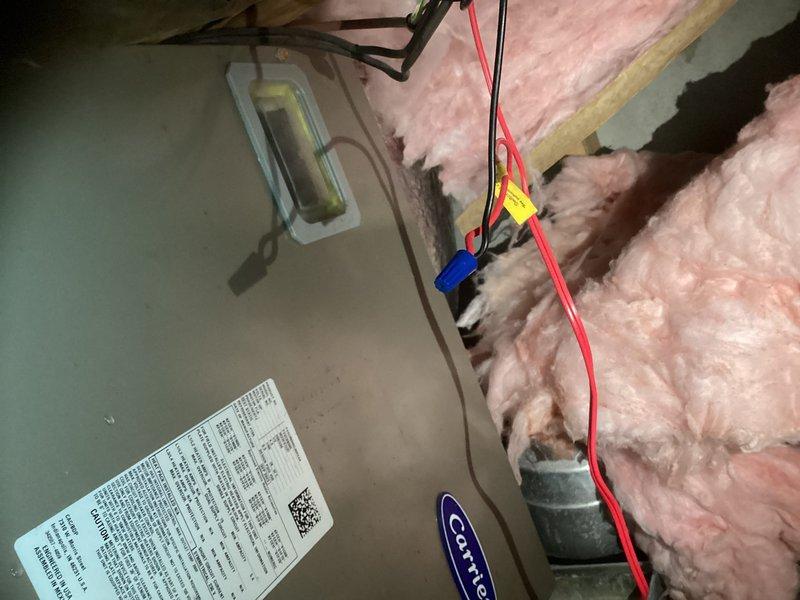 Conducted site assessment for complete HVAC system replacement with air handler relocation from current attic position to bathroom area. Evaluated existing Carrier air handler installation, inspected ductwork that has been spray foamed, and assessed attic conditions including pink fiberglass insulation, copper refrigerant lines, and flexible duct connections. Documented current system configuration and structural considerations for proposed relocation, noting that extensive drywall removal will be required prior to final measurements and equipment sizing. Discussed two replacement options: relocating current forced air system versus installing mini-split units for upper level. Determined that load calculation will be necessary due to building envelope modifications since original installation, including white reflective roofing and spray foam duct insulation, with potential for additional insulation and spray foam application after demolition phase.