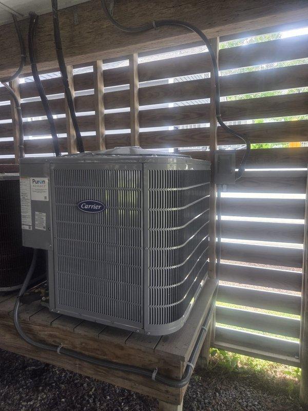 Removed and disposed of existing first floor HVAC system. Installed Carrier 27TPA824 2-ton 17 SEER heat pump condenser unit on existing outdoor stand with proper gravel base and deck clearance. Installed FT5ANXB024 variable speed fan coil unit with integrated 10KW electric heat strip and circuit breaker. Ran new electrical whip and installed disconnect box for outdoor unit. Flushed existing refrigerant lines, performed pressure test to verify system integrity, and recharged system to manufacturer specifications. Installed THX1200W WiFi-enabled programmable thermostat for system control. Verified all electrical connections, refrigerant charge, and airflow parameters. Conducted second floor system inspection to document equipment model and serial numbers for addition to maintenance agreement. System tested and operational upon completion.