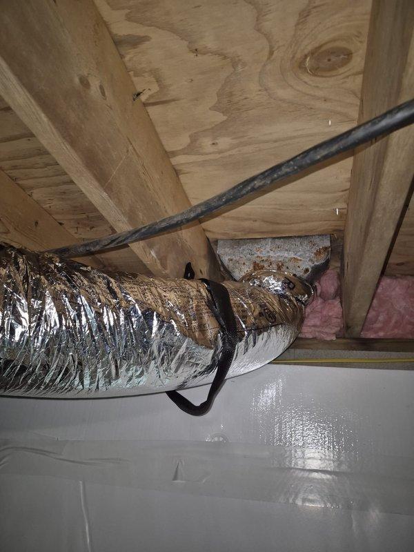 Replaced water-damaged 6" flexible ductwork in crawlspace located beneath the rear sliding glass door. Removed compromised flex line and installed new insulated flexible duct, properly secured with fabric straps to floor joists. Verified proper airflow and system operation upon completion.