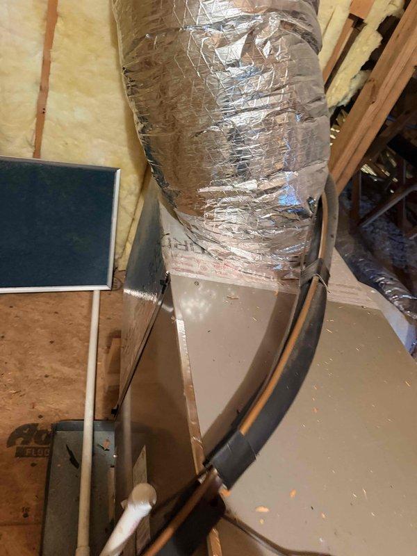 Responded to service call for HVAC system not maintaining temperature at property listed for sale. Upon inspection, found 22-year-old system was out of refrigerant, indicating likely refrigerant leak. Assessed attic-installed air handler and ductwork, documented existing equipment condition with photos, and provided comprehensive replacement estimate for new HVAC system due to age and refrigerant loss making repair economically unfeasible.
