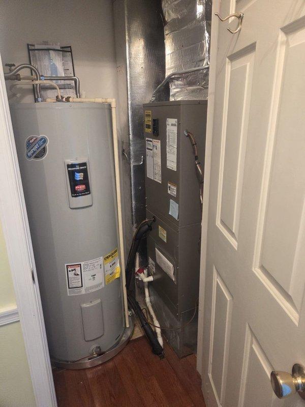 # HVAC Maintenance Service Completed

Performed comprehensive heating and cooling system maintenance on residential split HVAC system. Inspected indoor air handler unit located in utility closet alongside water heater, verifying proper operation of all components and connections. Examined refrigerant lines, electrical connections, and ductwork for signs of wear or damage. All indoor unit labels and safety information confirmed visible and legible.

Proceeded to outdoor condenser unit for external inspection and maintenance procedures. Accessed light green condenser unit positioned on concrete pad with brick border edging. Evaluated fan grille assembly, condenser coil condition, and overall unit operation. Verified proper clearances around equipment and checked for debris accumulation. Completed routine maintenance tasks on cooling system components as part of recurring service agreement. Both heating and cooling systems inspected and confirmed operational.