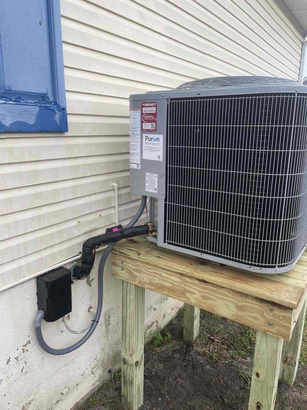 Completed full HVAC system replacement for mobile home, removing and disposing of existing equipment. Installed MG2R-72B 95% efficiency furnace, 27SCA542 3.5-ton heat pump outdoor unit on ground-level wooden platform, and 3.5-ton mobile home heat pump coil. Furnished and installed electrical whip with disconnect box, flushed and pressure tested refrigeration lines, and recharged system to manufacturer specifications. Utilized existing thermostat for system control. All equipment installed per manufacturer guidelines with one-year parts warranty coverage.