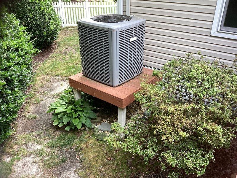 Responded to service call for residential HVAC system found to be low on refrigerant. Performed diagnostic evaluation of existing outdoor condenser unit and indoor air handler system. Homeowner declined refrigerant recharge and leak detection service, requesting full system replacement estimate instead. Documented current equipment configuration including outdoor condensing unit mounted on wooden platform and attic-installed air handler with associated ductwork and electrical connections for preparation of replacement proposal.