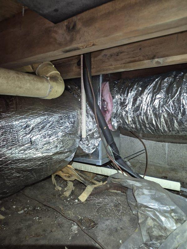 Responded to cooling complaint with indoor humidity reading at 75%. Performed comprehensive diagnostic evaluation of ductwork system and airflow performance. Conducted thorough inspection of crawl space and attic areas, examining all accessible ductwork runs, connections, and structural penetrations. 

Visual inspection revealed metallic supply ducts in attic space with reflective insulation wrap. Assessed duct sealing integrity at joints, connections, and boot terminations. Examined crawl space plumbing penetrations and floor joist areas for potential air infiltration paths affecting system performance. Documented existing ductwork configuration, insulation conditions, and potential leakage points throughout distribution system.

Evaluated overall system airflow characteristics and identified opportunities for duct sealing improvements to address humidity concerns. Provided customer information regarding Energize Delaware home energy assessment program for comprehensive leakage identi