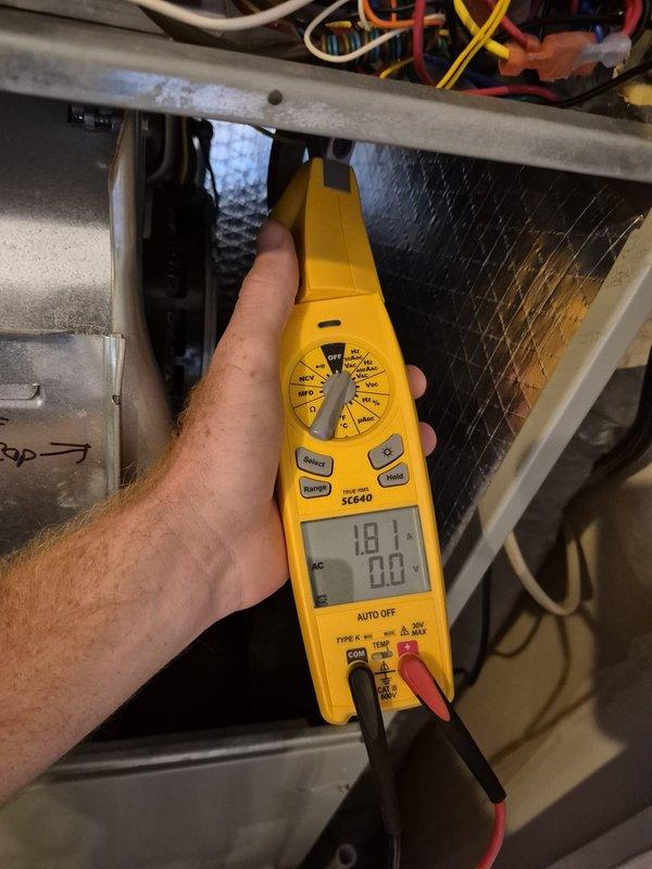 Performed scheduled heating maintenance visit on HVAC system. Conducted electrical diagnostics using multimeter to verify voltage readings and system amperage at the outdoor unit's electrical panel, measuring 22V and 0.58A with all readings within normal operating parameters. Inspected internal components and wiring connections, confirming all electrical connections were secure and system was operating properly for the heating season.