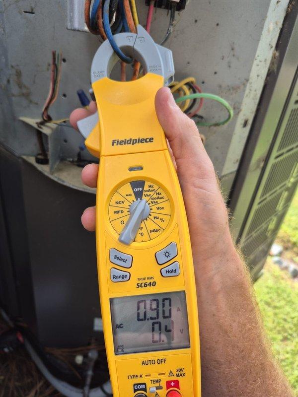 Performed comprehensive HVAC system inspection and tune-up service. Verified 14x14x1 air filter condition and proper installation in return air grille. Conducted electrical diagnostics using clamp meter to measure amperage draw and verify system performance parameters. Cleared condensate drain line to ensure proper drainage and prevent water backup. Documented system operation with photographic evidence showing filter condition and electrical measurements within normal operating range.