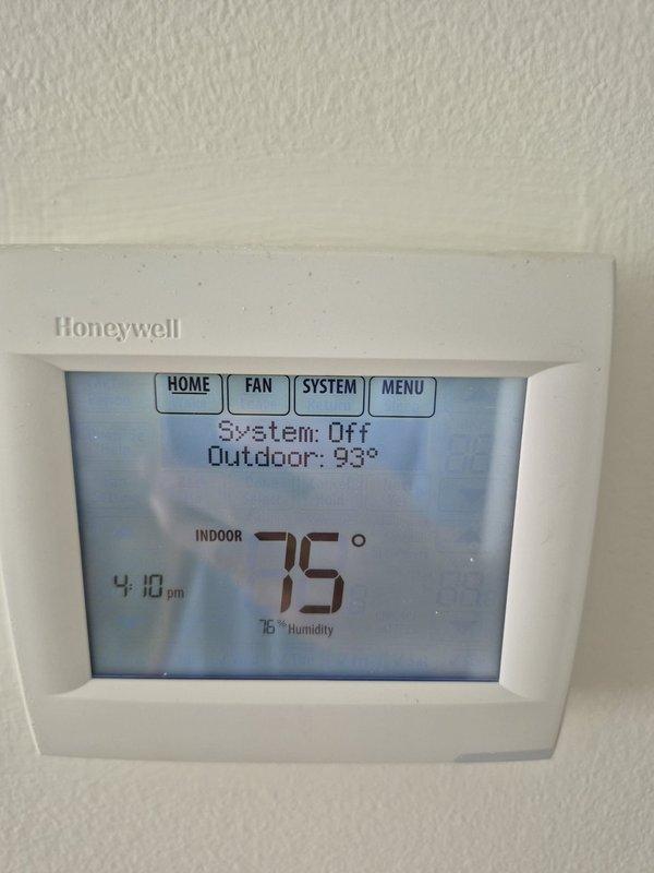 Responded to no-cool complaint with inadequate cooling upstairs and downstairs not cooling, indoor humidity at 70% and system not maintaining setpoint. Upon arrival, found system turned off with fan set to ON position and thermostat reading 75°F indoor temperature with 93°F outdoor ambient. Performed diagnostic testing on outdoor unit and measured run capacitor at 5.11 microfarads, indicating capacitor failure below rated specifications. Replaced defective dual run capacitor, restored system to normal operation, and verified proper cooling cycle with adequate airflow to both zones.