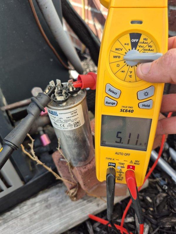 Responded to no-cool complaint with inadequate cooling upstairs and downstairs not cooling, indoor humidity at 70% and system not maintaining setpoint. Upon arrival, found system turned off with fan set to ON position and thermostat reading 75°F indoor temperature with 93°F outdoor ambient. Performed diagnostic testing on outdoor unit and measured run capacitor at 5.11 microfarads, indicating capacitor failure below rated specifications. Replaced defective dual run capacitor, restored system to normal operation, and verified proper cooling cycle with adequate airflow to both zones.