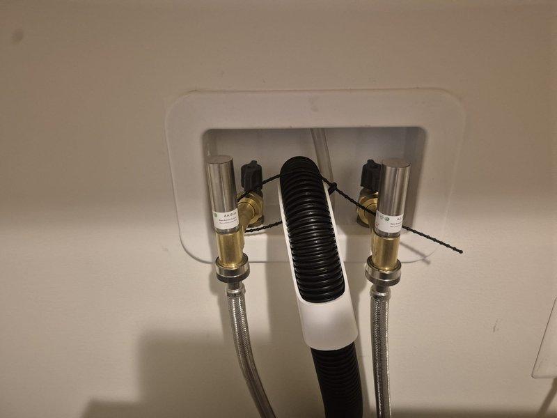 Responded to customer inquiry regarding water heater, washing machine, and dryer sharing a common supply line with potential code compliance concerns. Documented existing plumbing configuration showing wall-mounted connection box with braided stainless steel supply lines and shutoff valves serving laundry appliances. Advised customer that diagnostic assessment would be required to evaluate whether dedicated supply lines are needed and recommended scheduling technical evaluation with qualified plumber to determine code requirements and proper installation specifications.