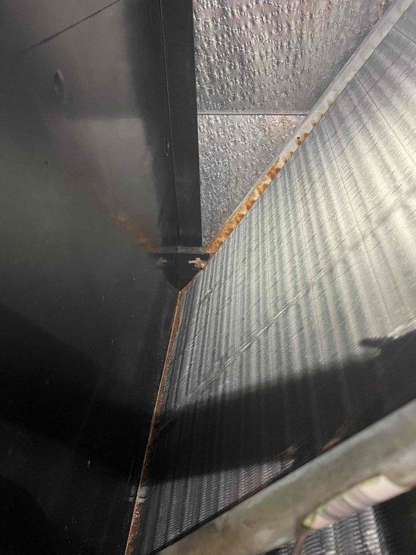 Performed system inspection and heat check on residential HVAC unit. Added 1 lb of 410a refrigerant with UV dye to system to facilitate leak detection. Documented rust discoloration at evaporator coil junction indicating potential moisture exposure requiring future dye inspection for leak confirmation.
